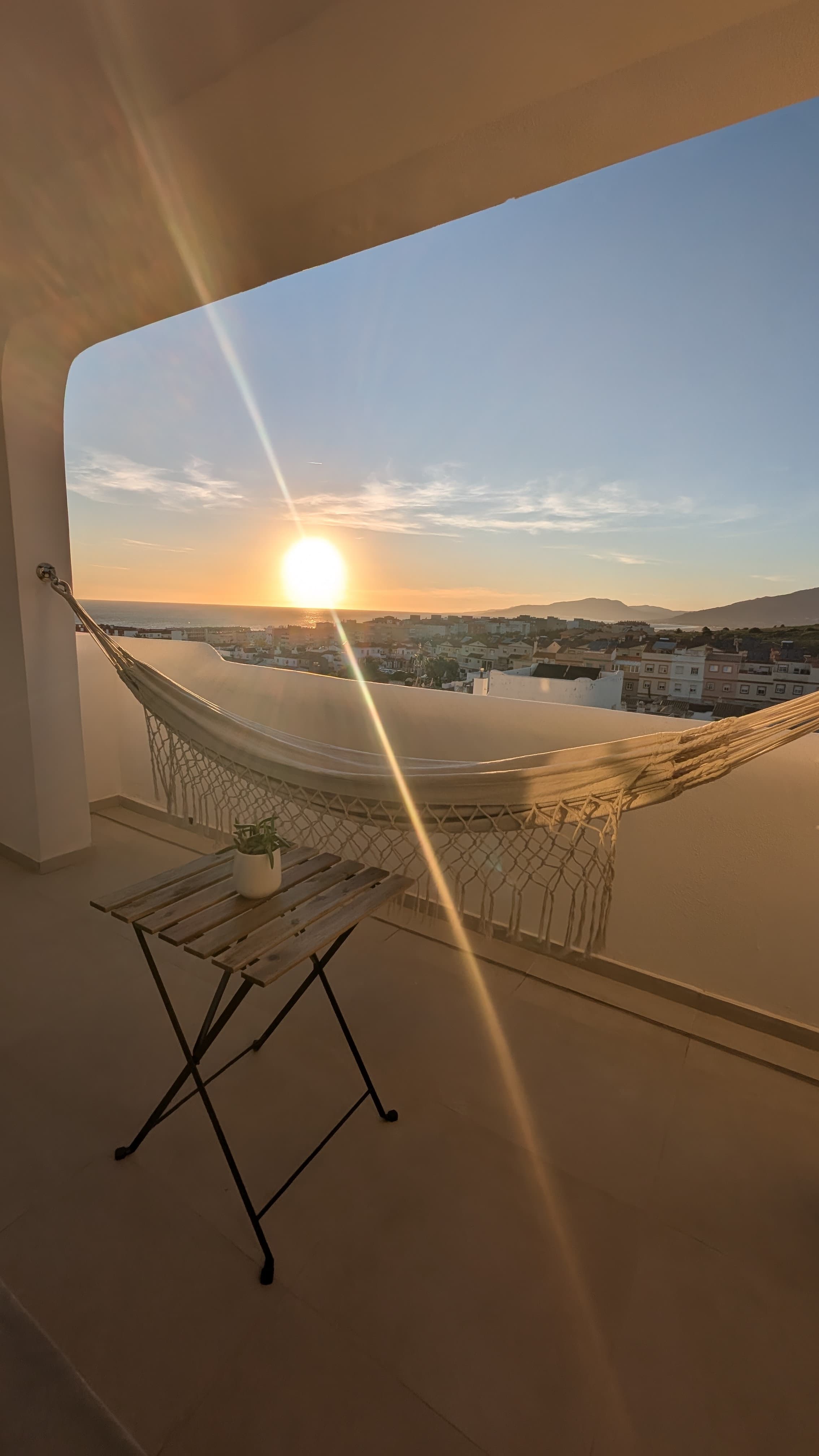 Hammock through the arched window at golden hour
