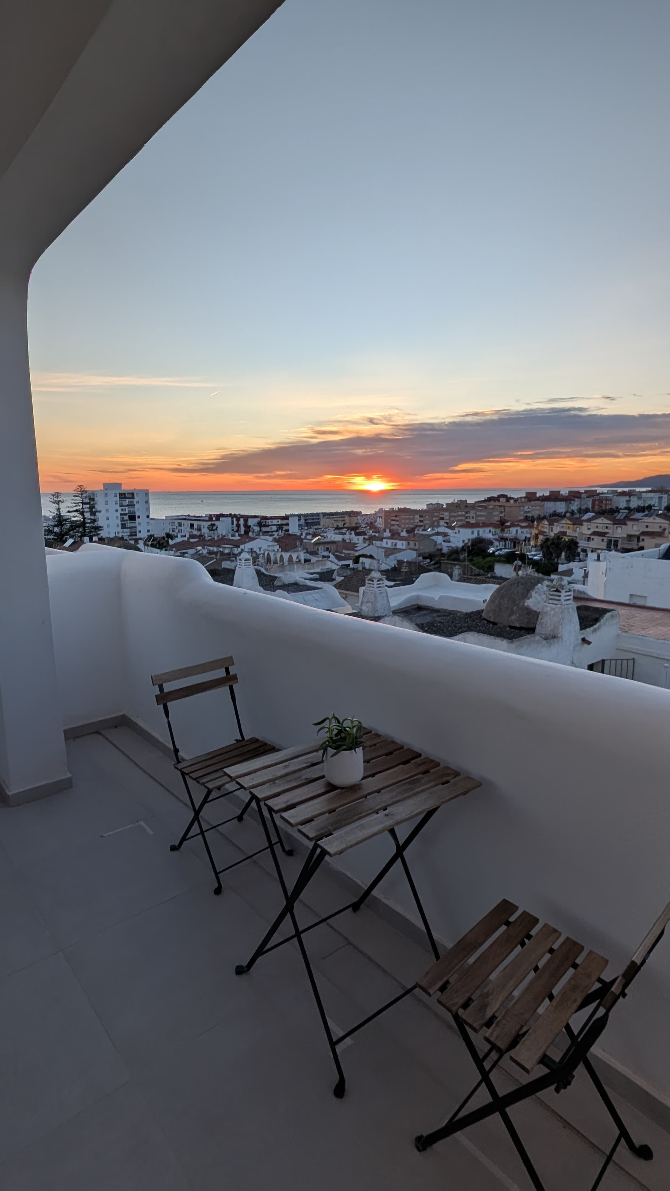 Terrace with bistro table and dramatic sunset sky
