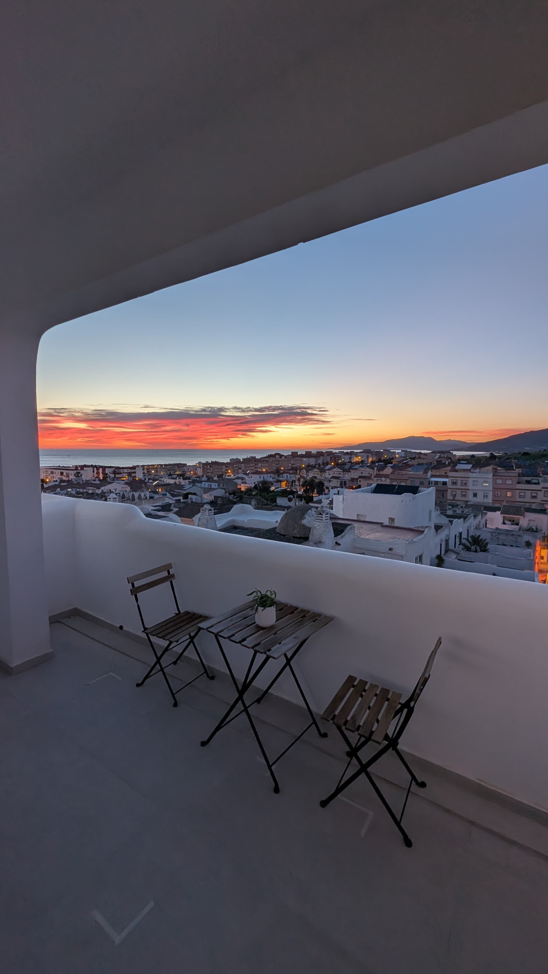 Tarifa at dusk with city lights below