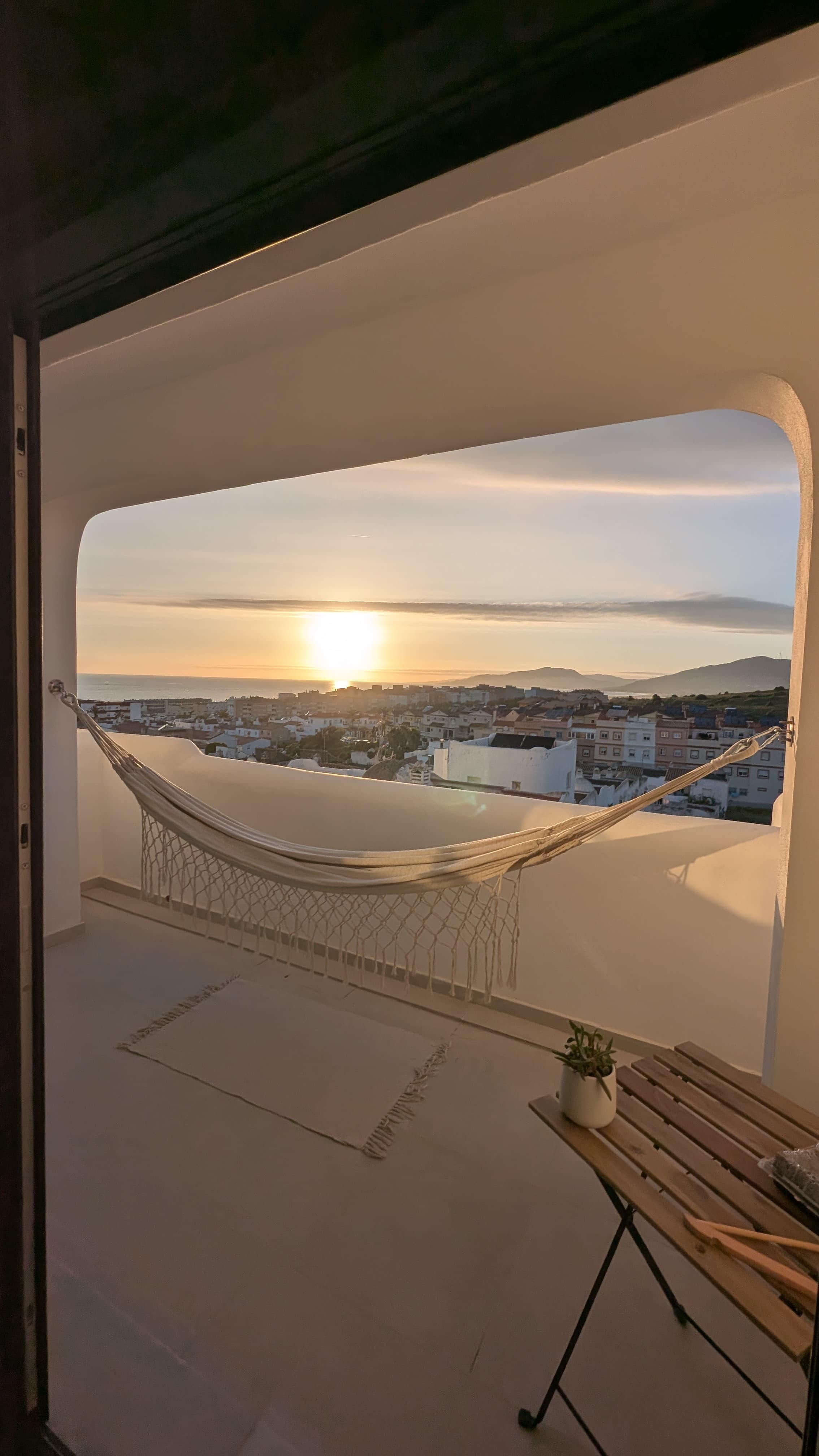 Terraza Atlántica Tarifa — view through the arched terrace to the Atlantic Ocean and Tarifa at sunset