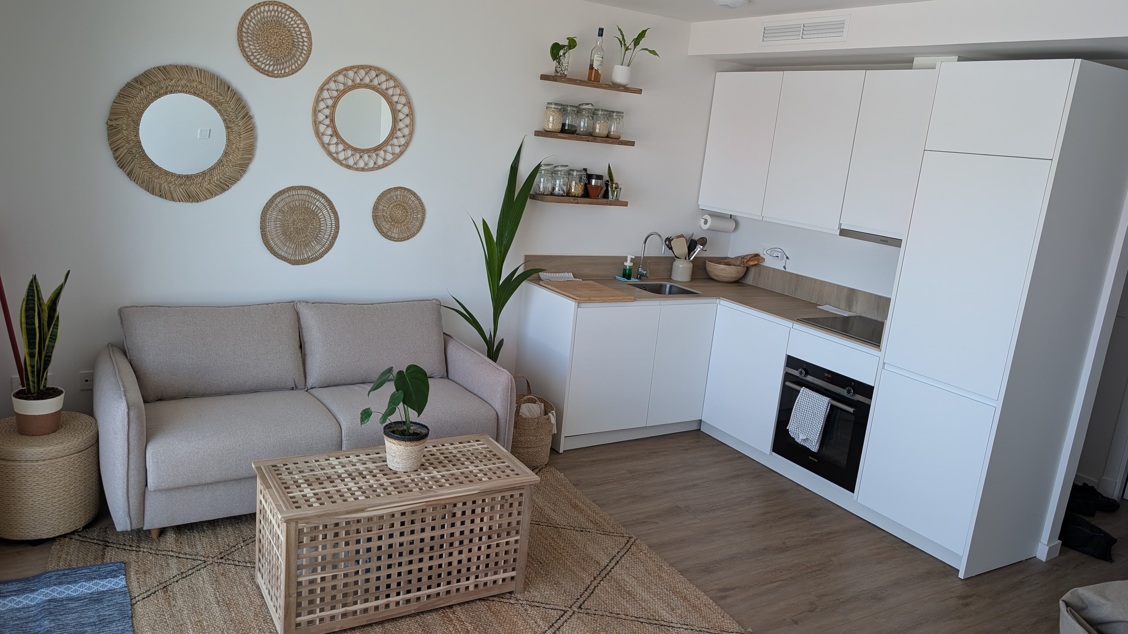 Fully equipped kitchen with white units and wood worktop