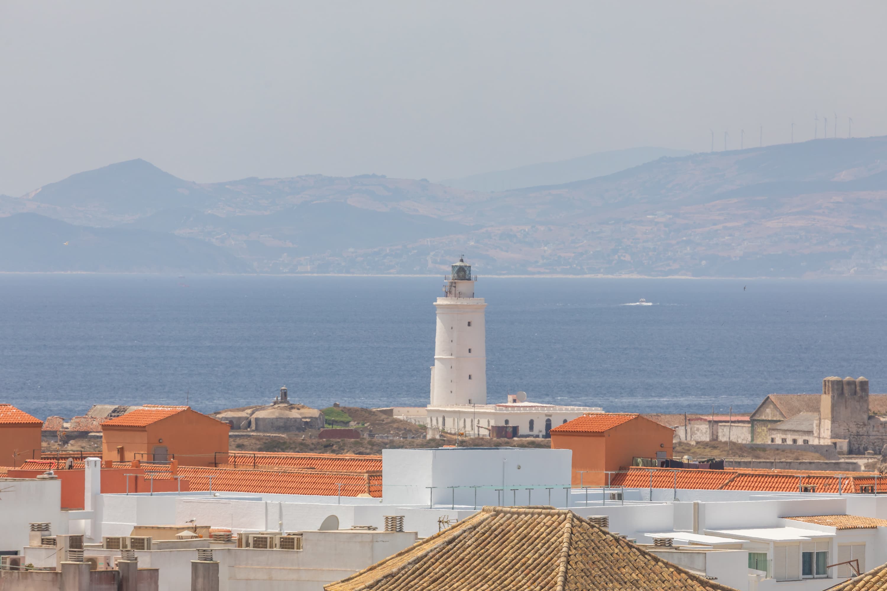 Tarifa lighthouse on Isla de las Palomas with Africa visible across the Strait of Gibraltar