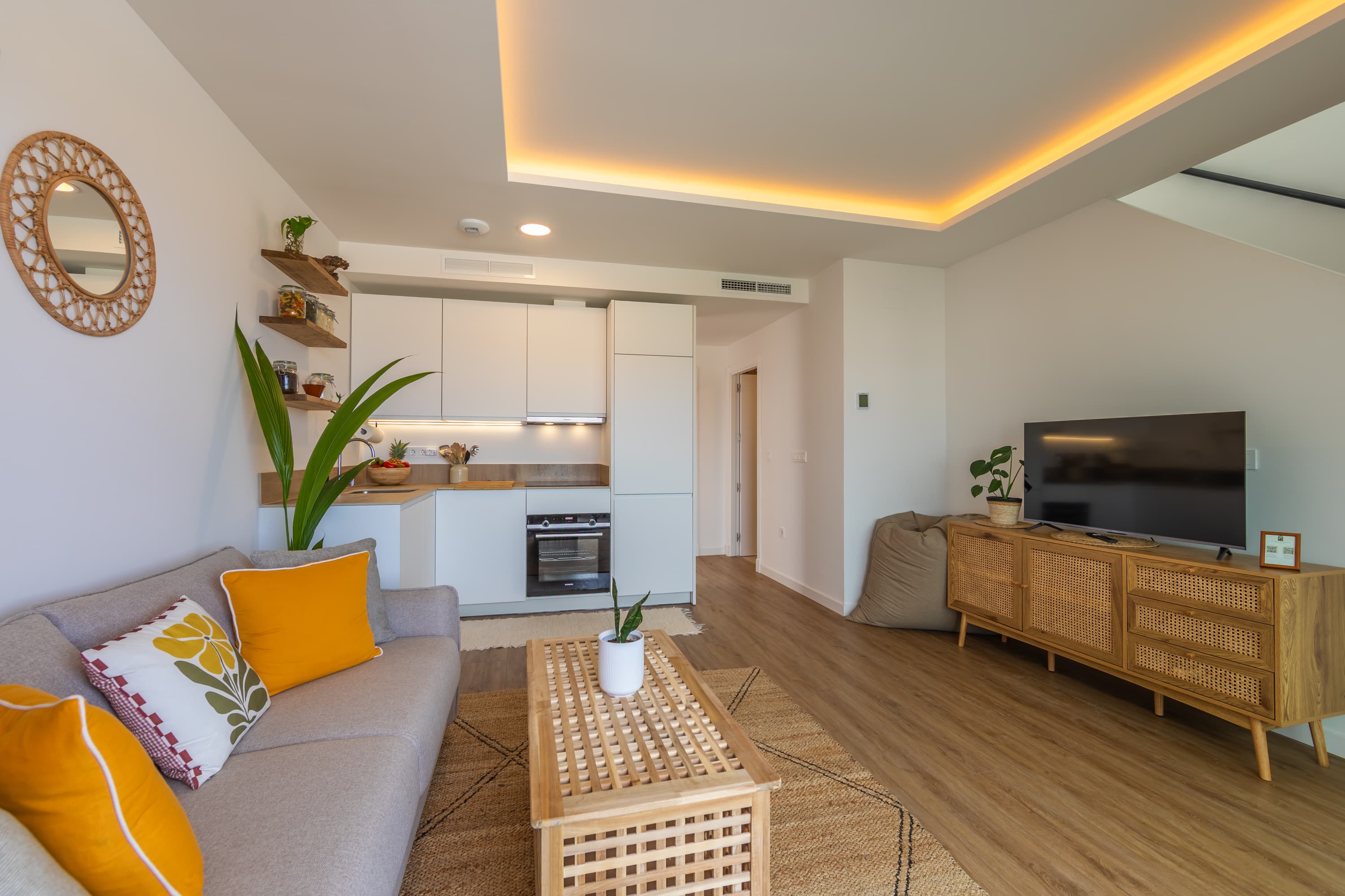 Open-plan living room with natural light, comfortable sofa and modern furnishings