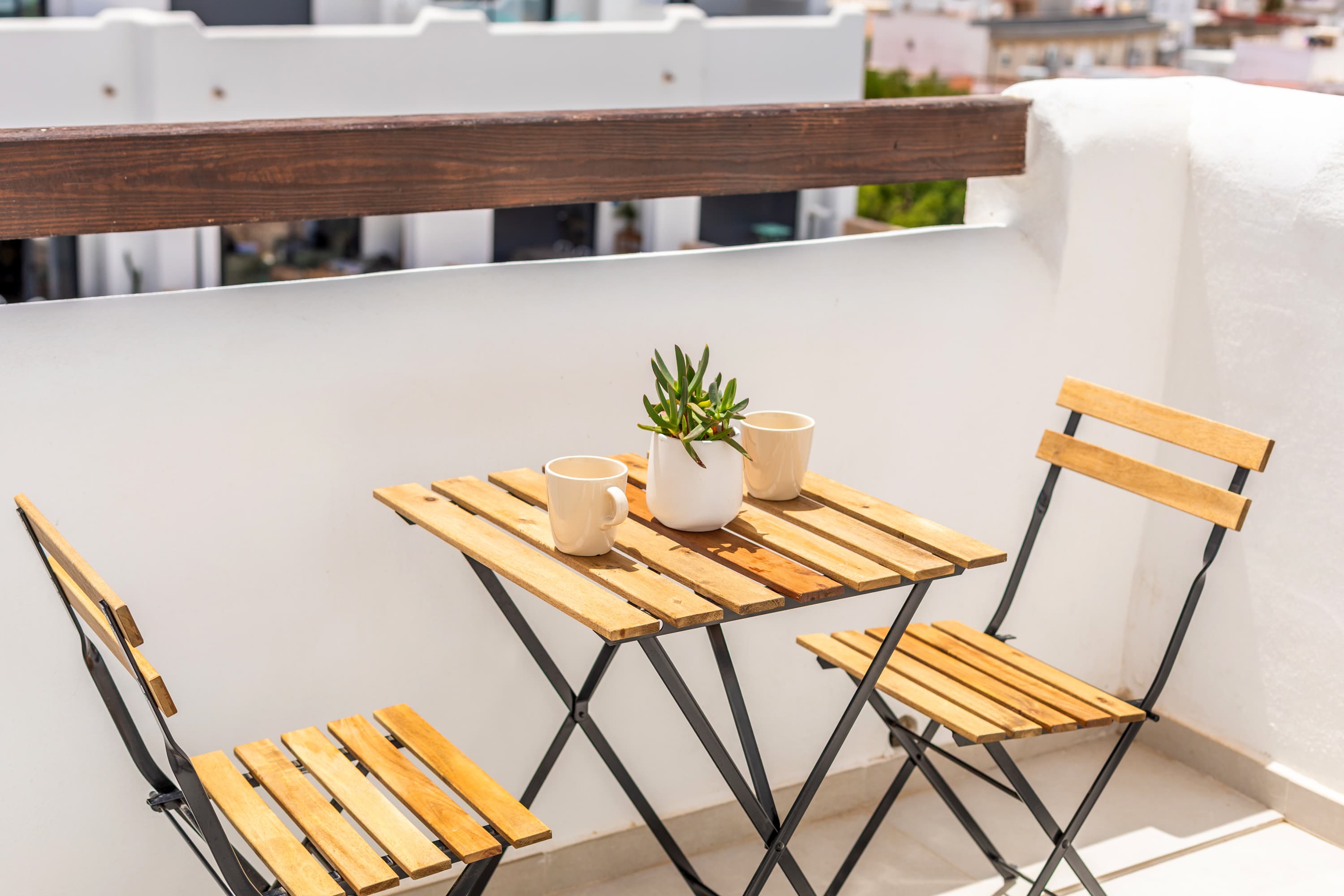 Mediterranean Terrace bistro table with two coffee cups and a succulent, morning light